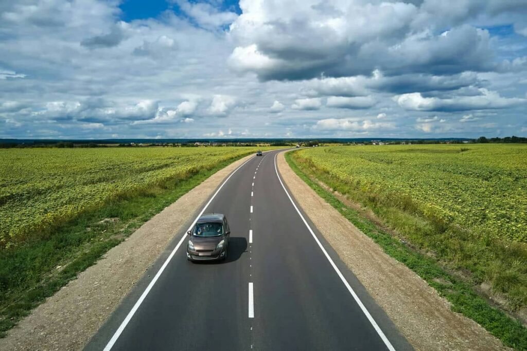 aerial-view-of-intercity-road-between-green-agricu-2023-11-27-04-59-39-utc - Tyre Shop Singapore | Tire Pte Ltd Hybrid tyres | tyre shop singapore | tire pte ltd
