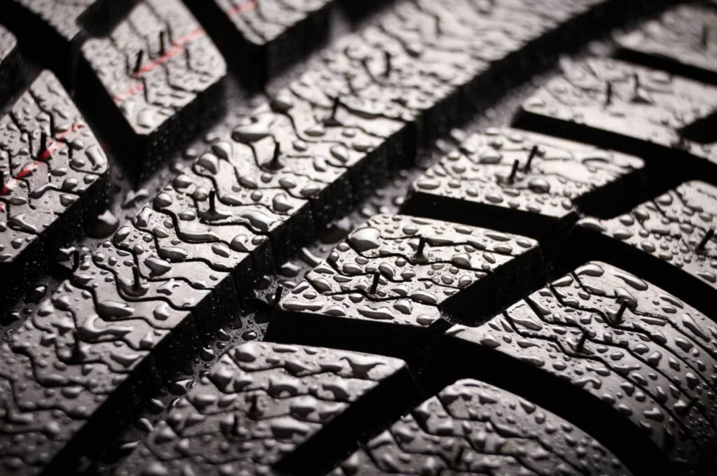 Brand new winter tire pattern on black background. - Tyre Shop Singapore | Tire Pte Ltd Wet grip in hybrid tires | tyre shop singapore | tire pte ltd