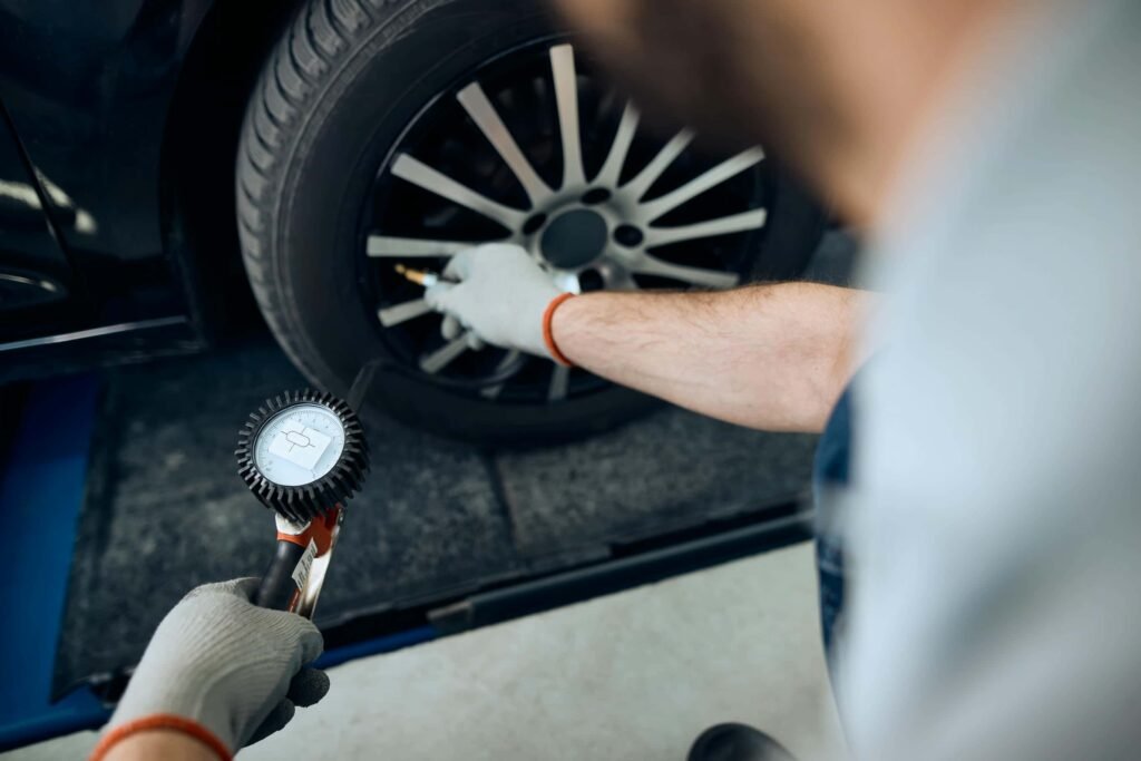 close-up-of-mechanic-using-pressure-gauge-while-ex-2023-11-27-05-16-54-utc - Tyre Shop Singapore | Tire Pte Ltd Tire pressure | tyre shop singapore | tire pte ltd