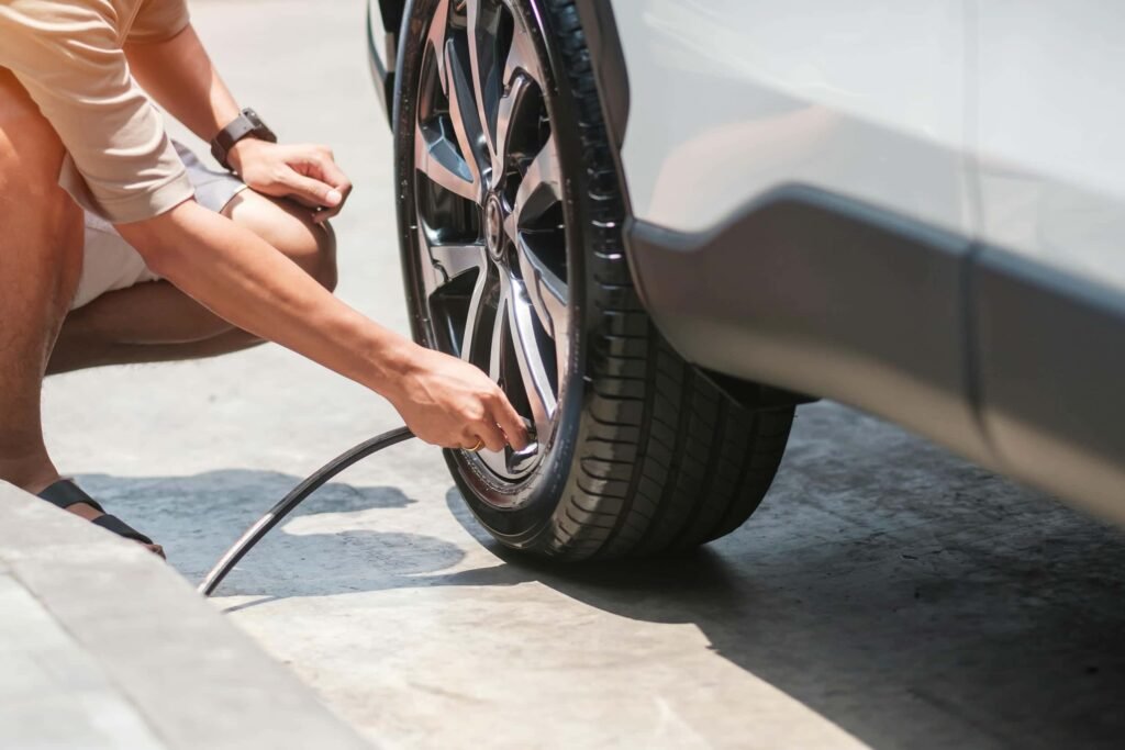 man-driver-hand-inflating-tires-of-vehicle-removi-2023-11-27-05-05-16-utc - Tyre Shop Singapore | Tire Pte Ltd Tire pressure | tyre shop singapore | tire pte ltd