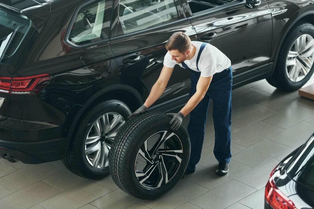 replacement-of-wheel-young-man-in-white-shirt-and-2023-11-27-05-14-25-utc - Tyre Shop Singapore | Tire Pte Ltd | tyre shop singapore | tire pte ltd