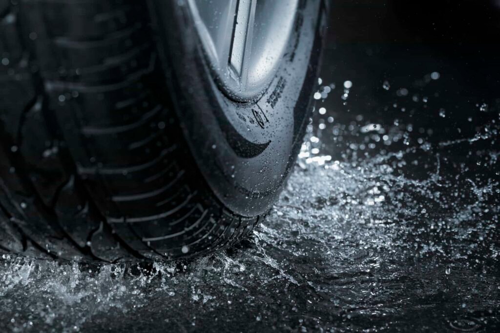 Car tire splashing in water. - Tyre Shop Singapore | Tire Pte Ltd Wet grip in hybrid tires | tyre shop singapore | tire pte ltd
