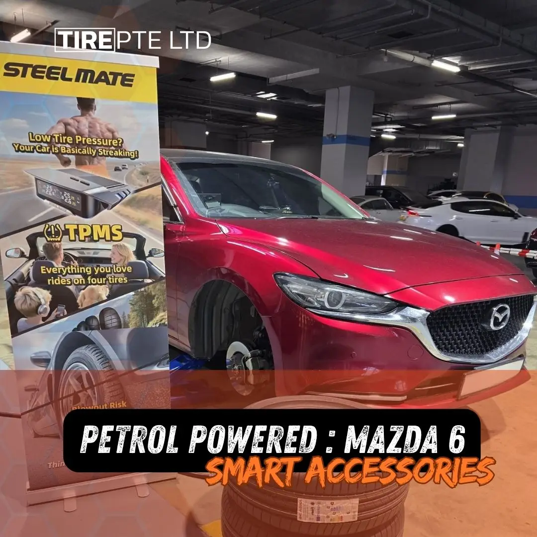 Red mazda sedan on a lift in a dim showroom with a banner advertising steel mate tpms and four tire rides overlaid with bold orange text about petrol powered mazda 6 smart accessories | tyre shop singapore | tire pte ltd | tyre shop singapore | tire pte ltd